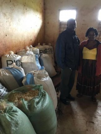 Father_Vitals_with_Deputy_head_Levina_at_Nyaishozi_Primary_with_the_home_grown_maize