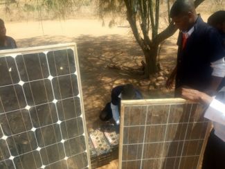 Students inspecting solar panels