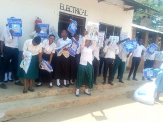 The students showing off their mosquito nets