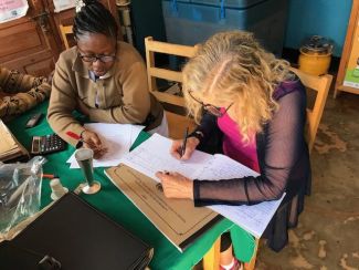 Signing_the_visitors_book_with_Rebecca_our_midwife_at_Nyaishozi_Dispensary