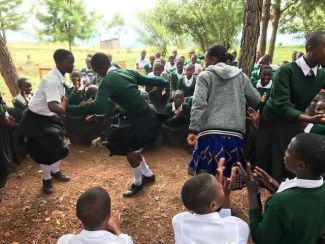 The_Rugu_girls_dancing_with_the_matron_from_Nyaishozi_Secondary_School_who_took_the_DfG_course_there
