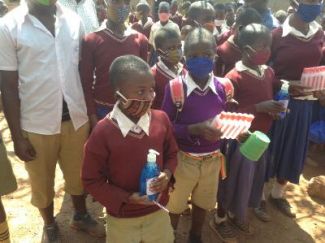 Nyakasimbi students queuing up for their hand sanitiser