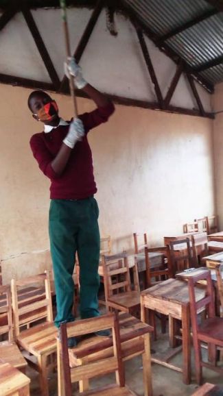 Ruhinda schoolboy cleaning the school for reopening