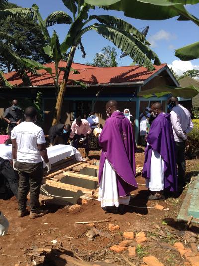 Father Vitalis taking the funeral service and burial of a victim of Covid-19