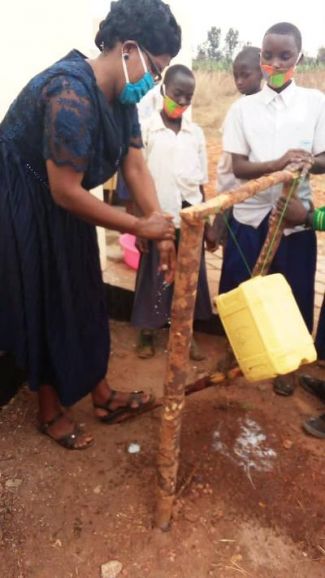 The Deputy Head at Nyaishozi Primary showing the children how to use a 